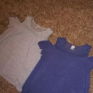 Two off the shoulder blouses on gray on blue